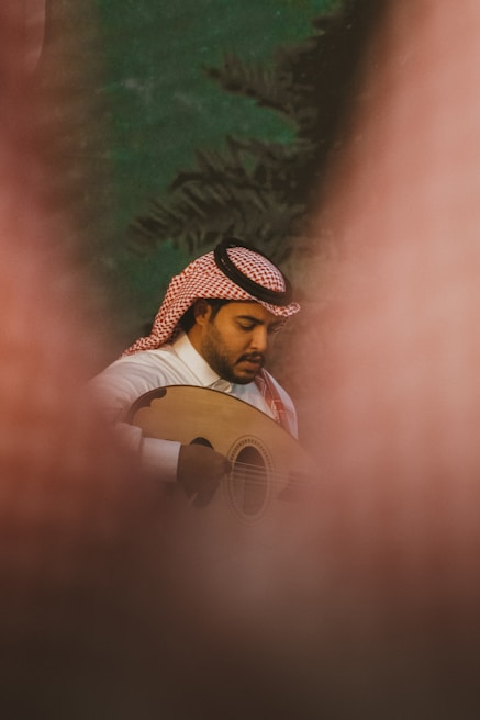 Traditional musicians playing oud and darbuka at a cultural festival.