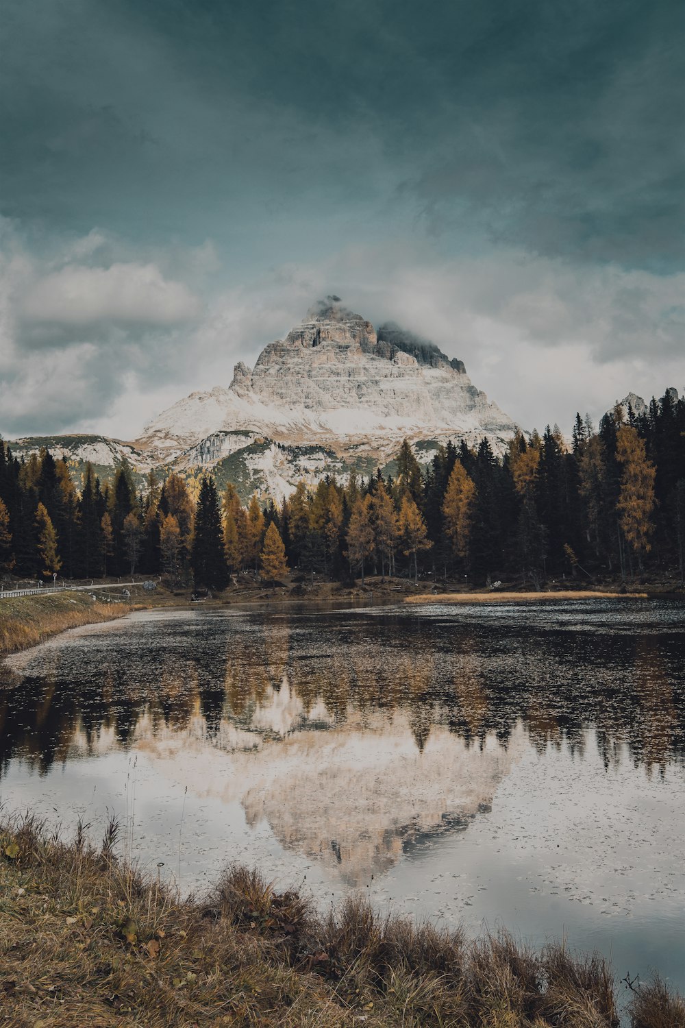 a snowy mountain behind a lake