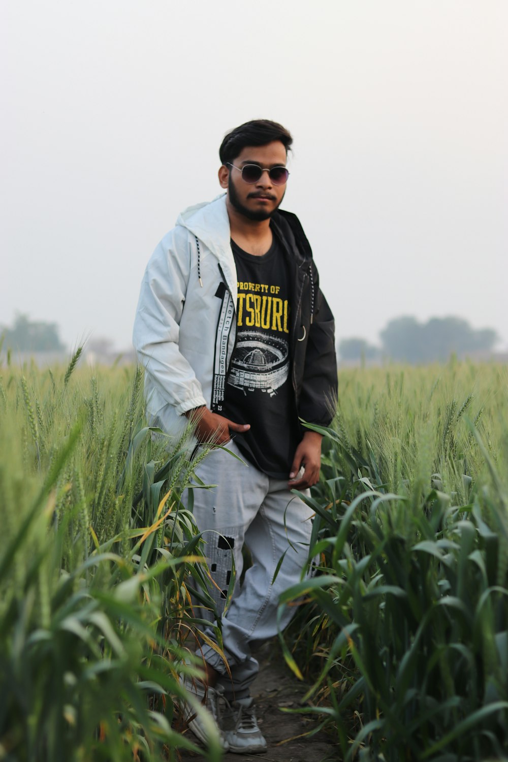 a man standing in a field of tall grass