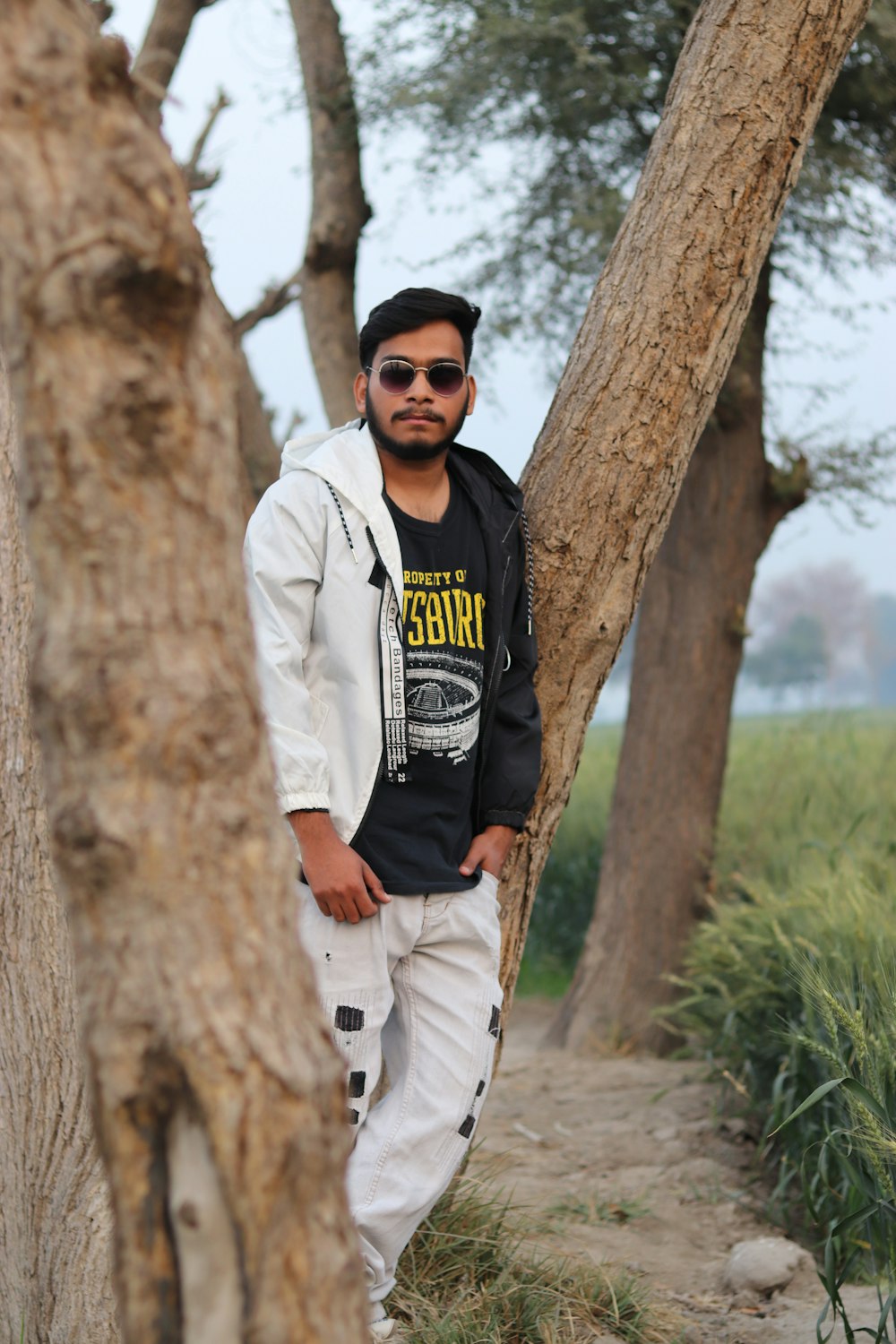 a man standing between two trees