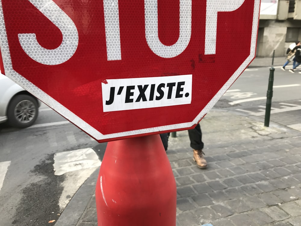a stop sign on the sidewalk