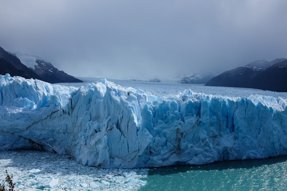 a large glacier in the water with Perito Moreno Glacier in the background