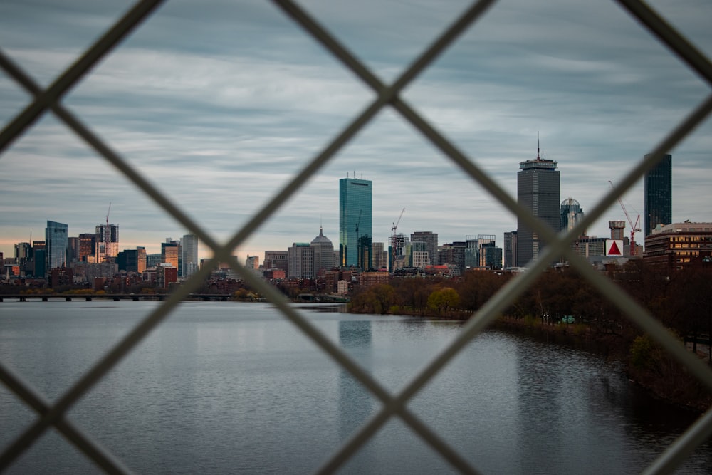 a bridge over a river with a city in the background