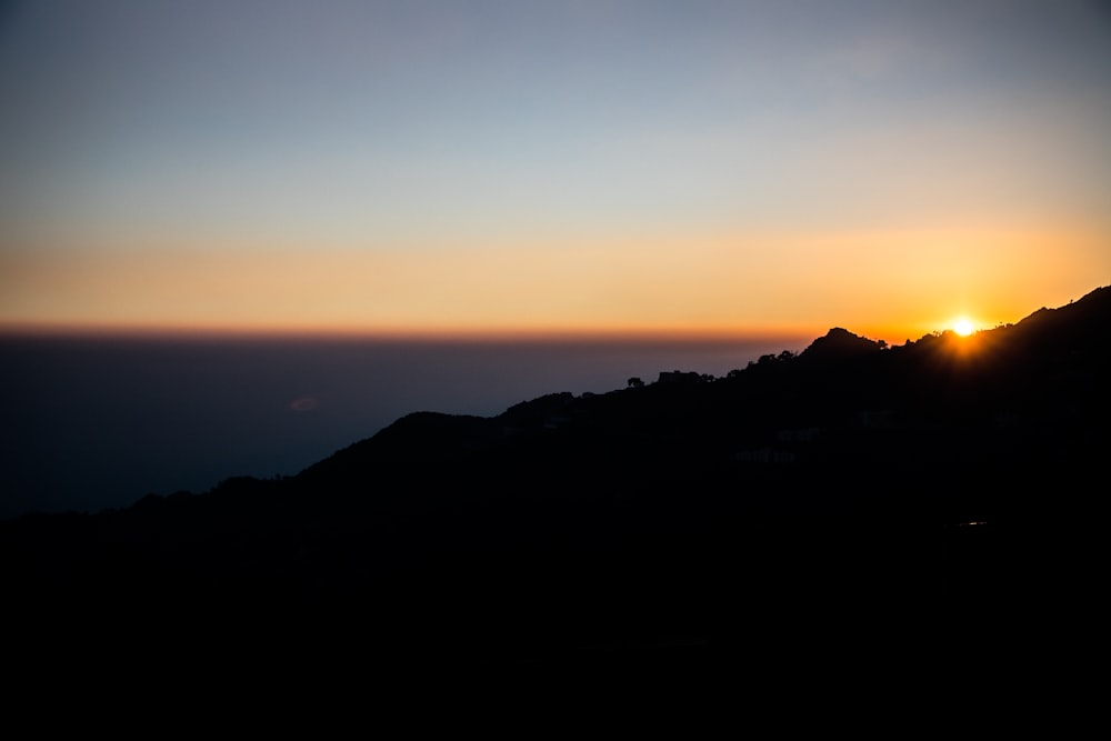 a sunset over a mountain