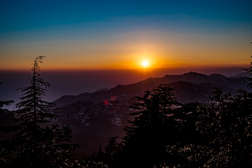 a sunset over a mountain range