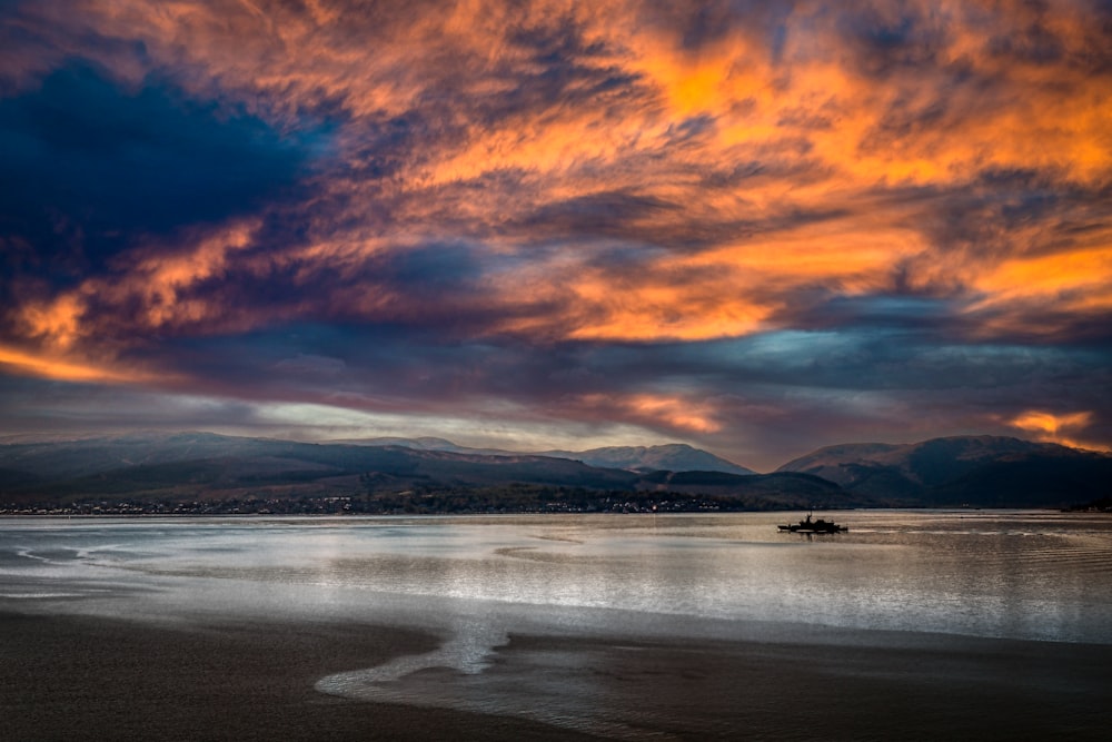 a body of water with mountains in the background