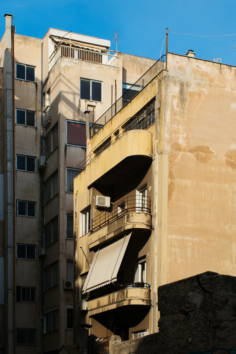 a building with balconies and a blue sky