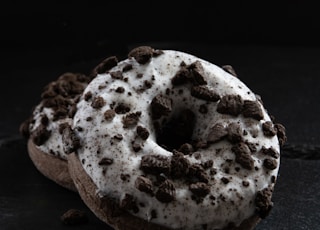 Two Oreo donuts stacked on top of each other on a black background