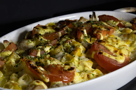 Close-up of a delicious homemade dish being plated in a warm kitchen setting.