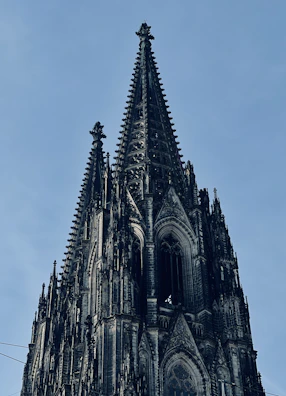 Visitors admiring the towering spires against a clear blue sky.