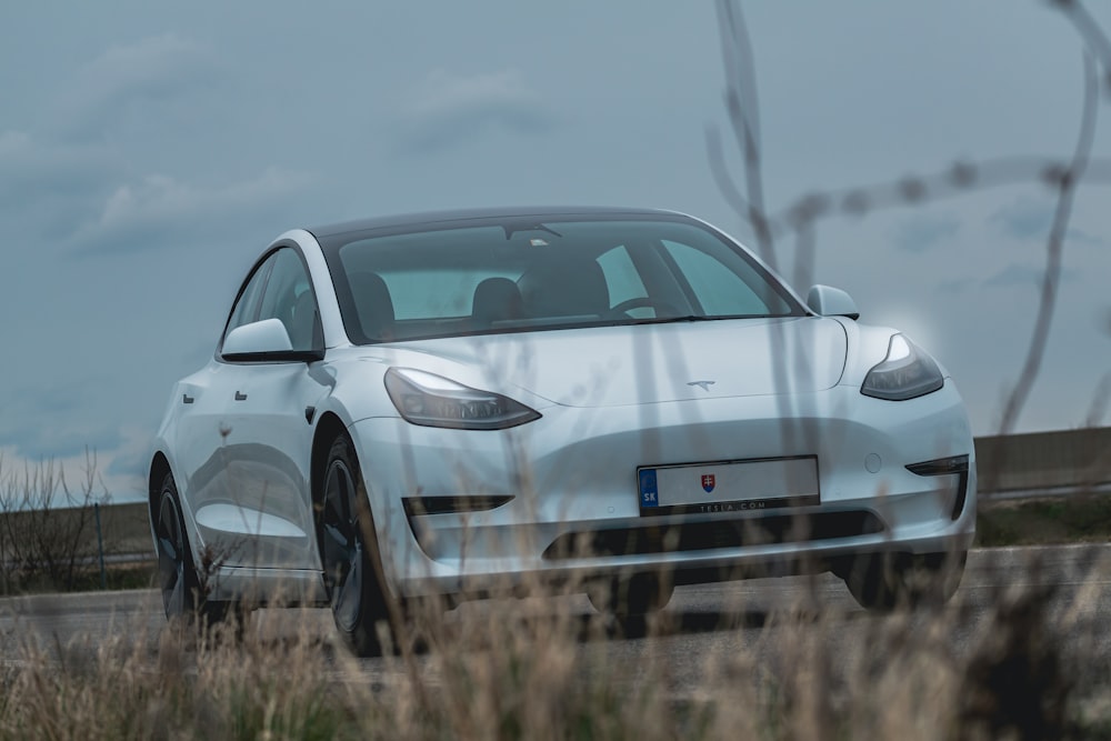 a white car parked in a field