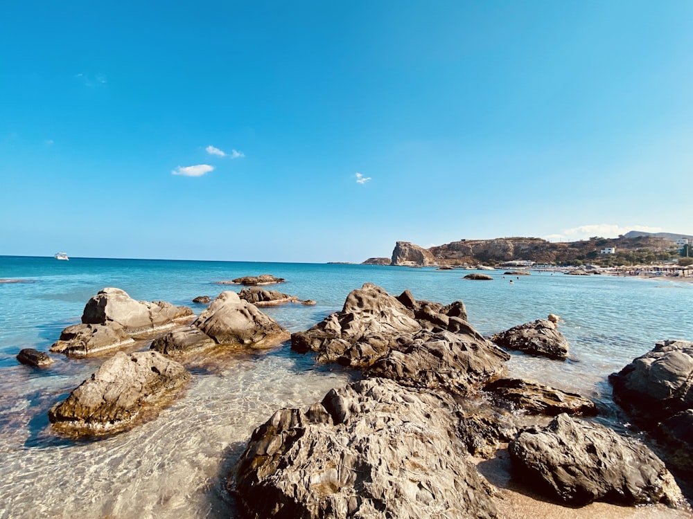 a rocky beach with blue water