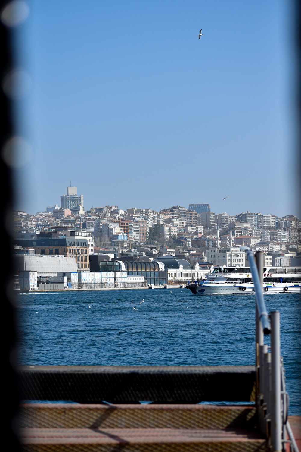 a view of a city across the water from a balcony