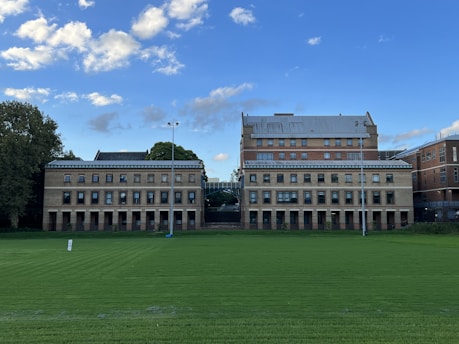 a large building with a green lawn