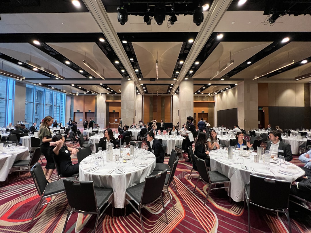 a group of people sitting at tables,