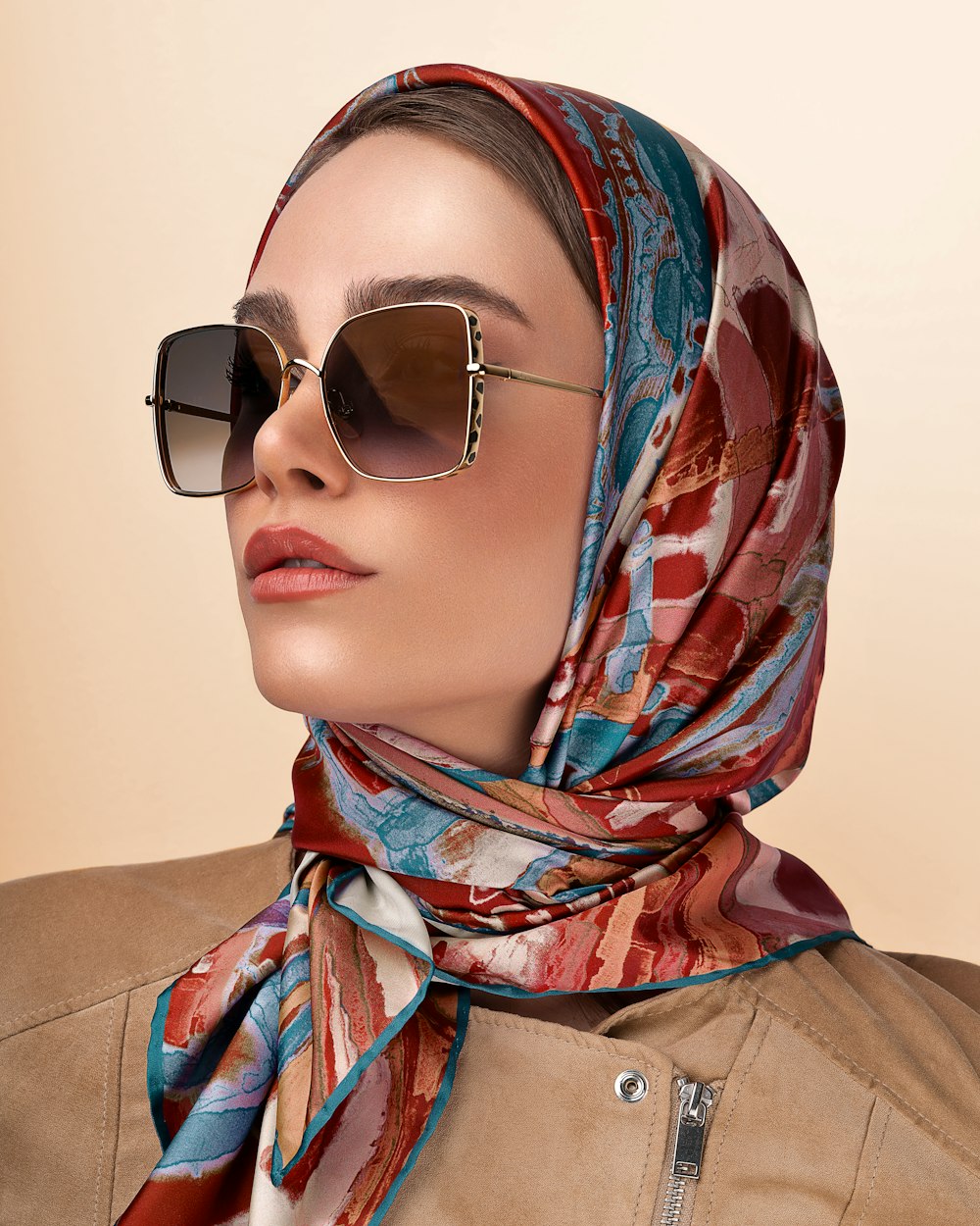 a person wearing a head scarf and sunglasses