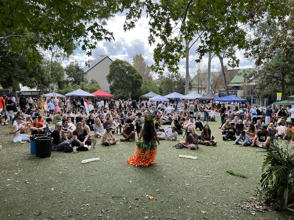 a group of people sitting on the ground