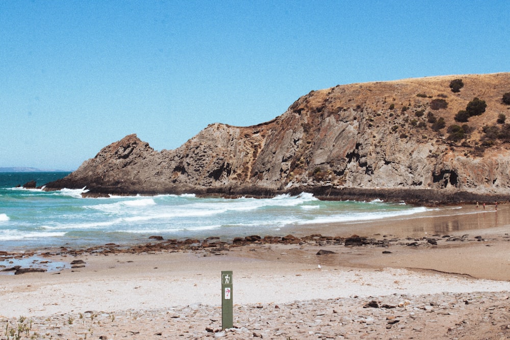 a beach with a hill in the background