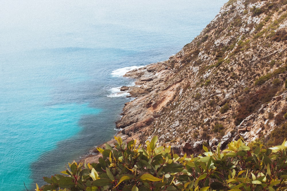 a cliff with a body of water below