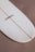 Close-up of a repaired surfboard with visible patchwork and sanding marks.