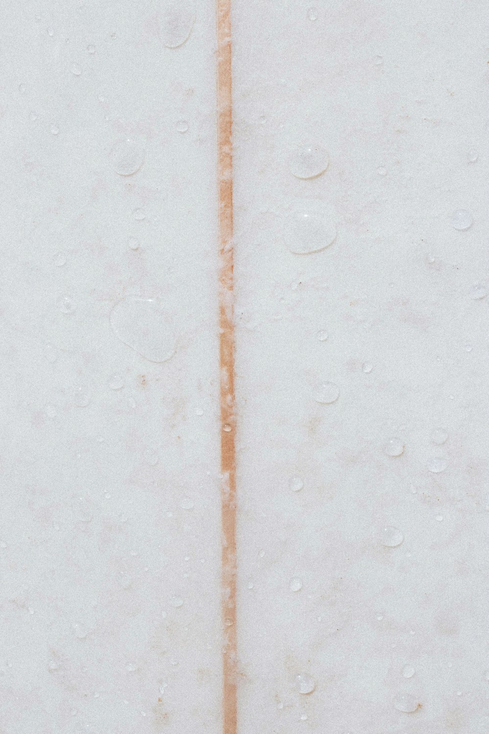 a white wall with a brown line