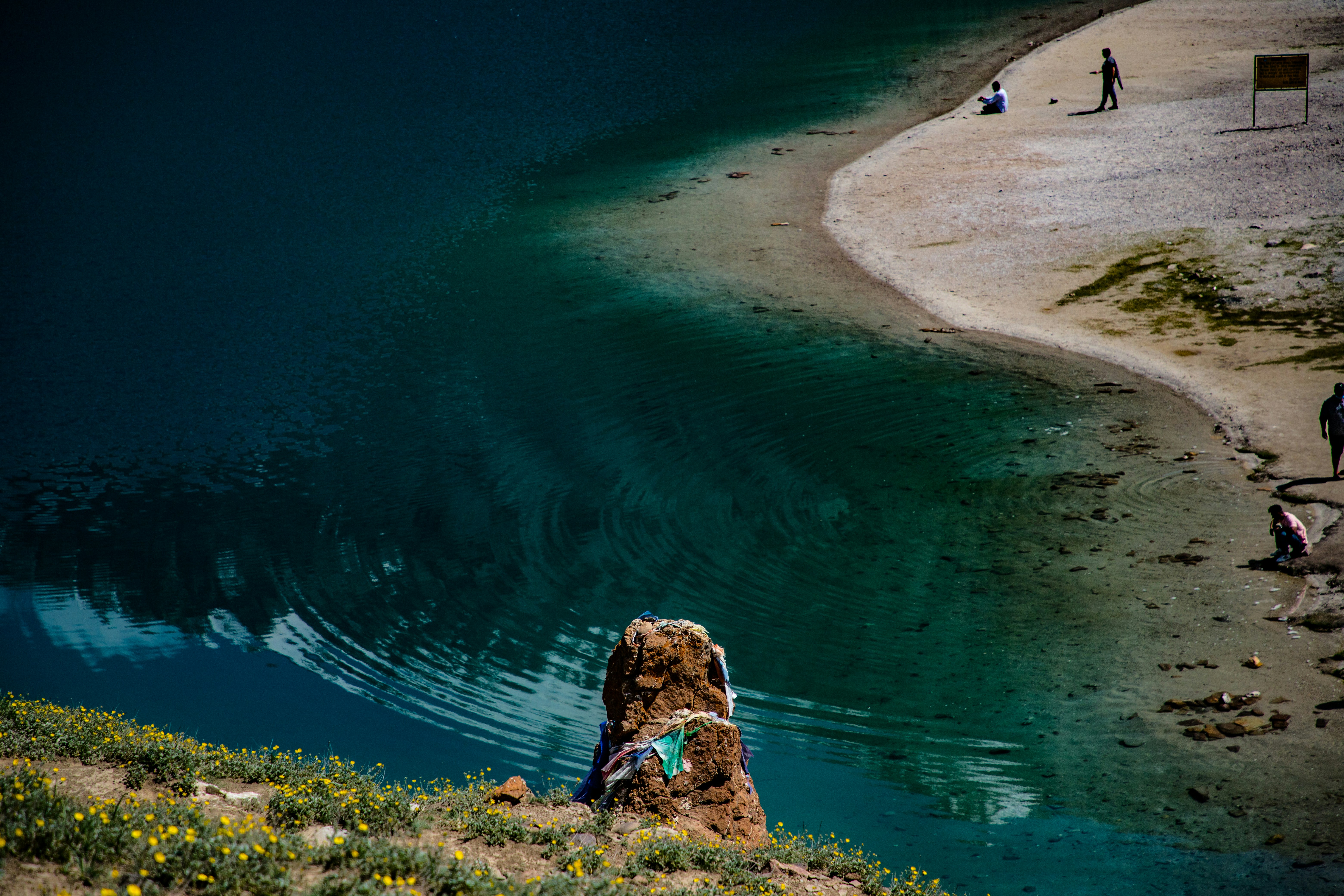 Deoria Tal alpine lake reflecting snow-capped Himalayan peaks at dawn