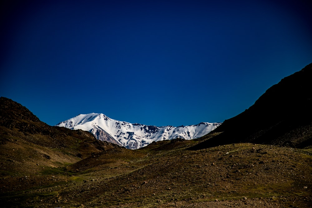 a snowy mountain in the distance