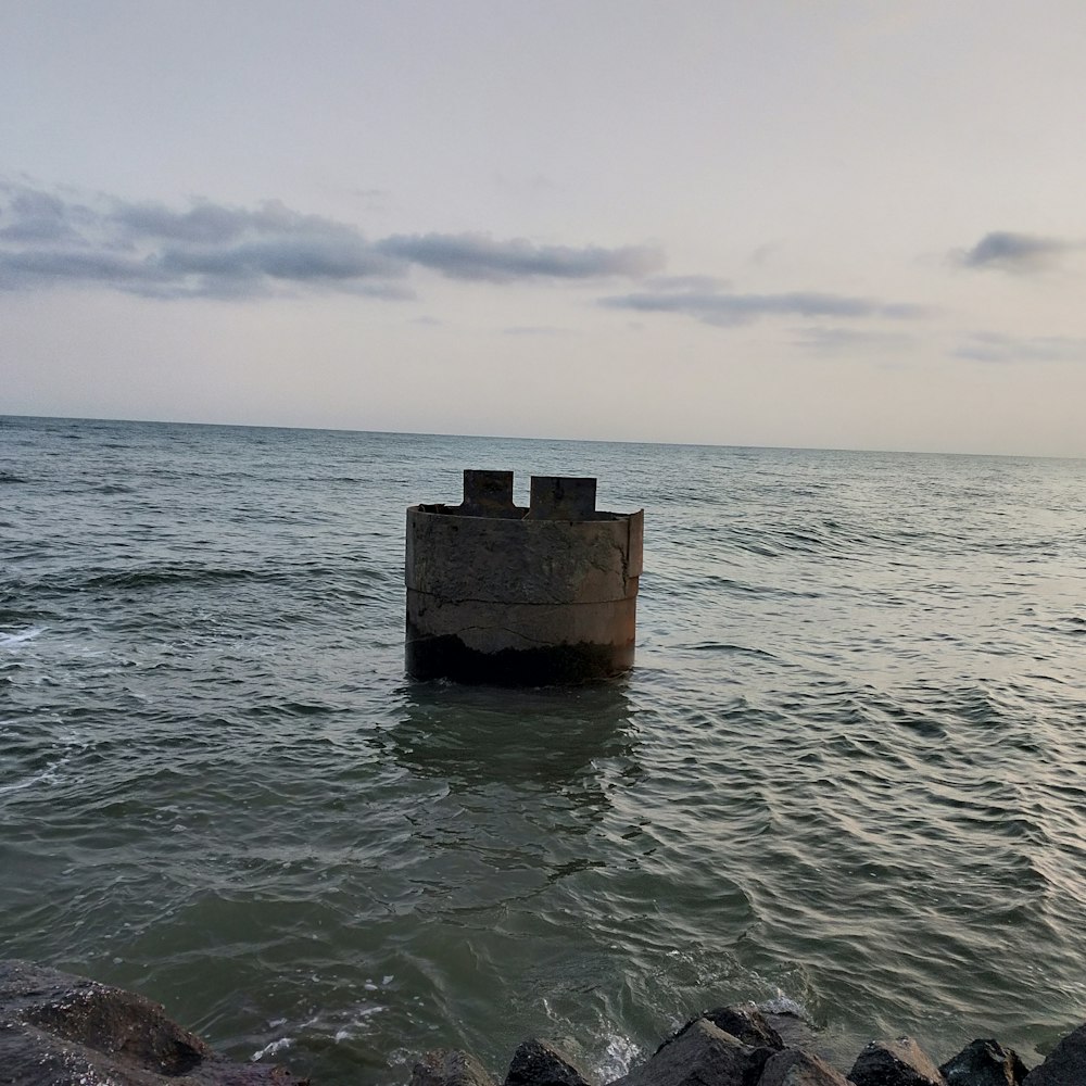 a stone structure in the middle of a body of water