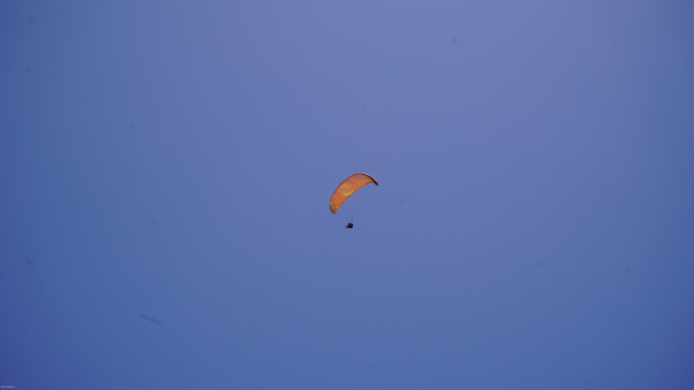 a person in the air with a parachute