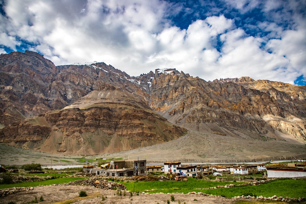 a building in the middle of a valley between mountains