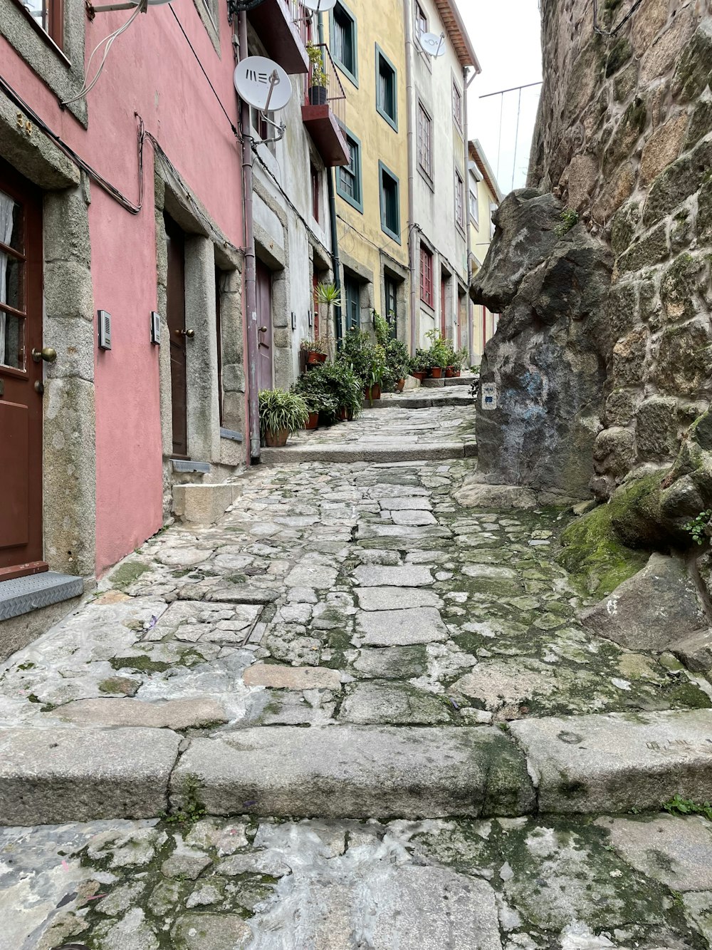 a cobblestone street between buildings