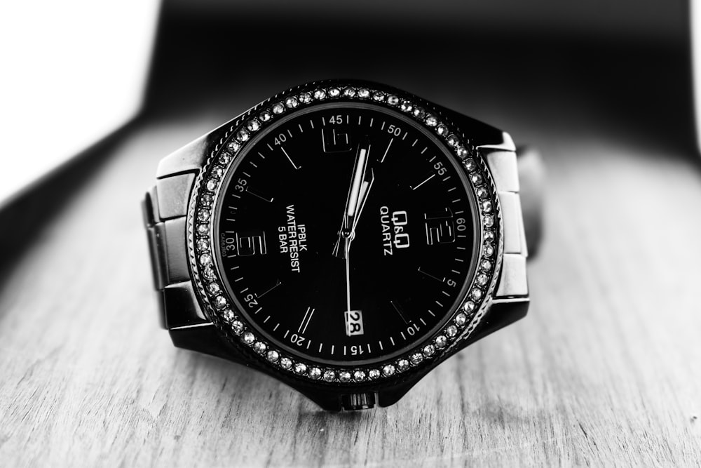 a black watch on a leather surface