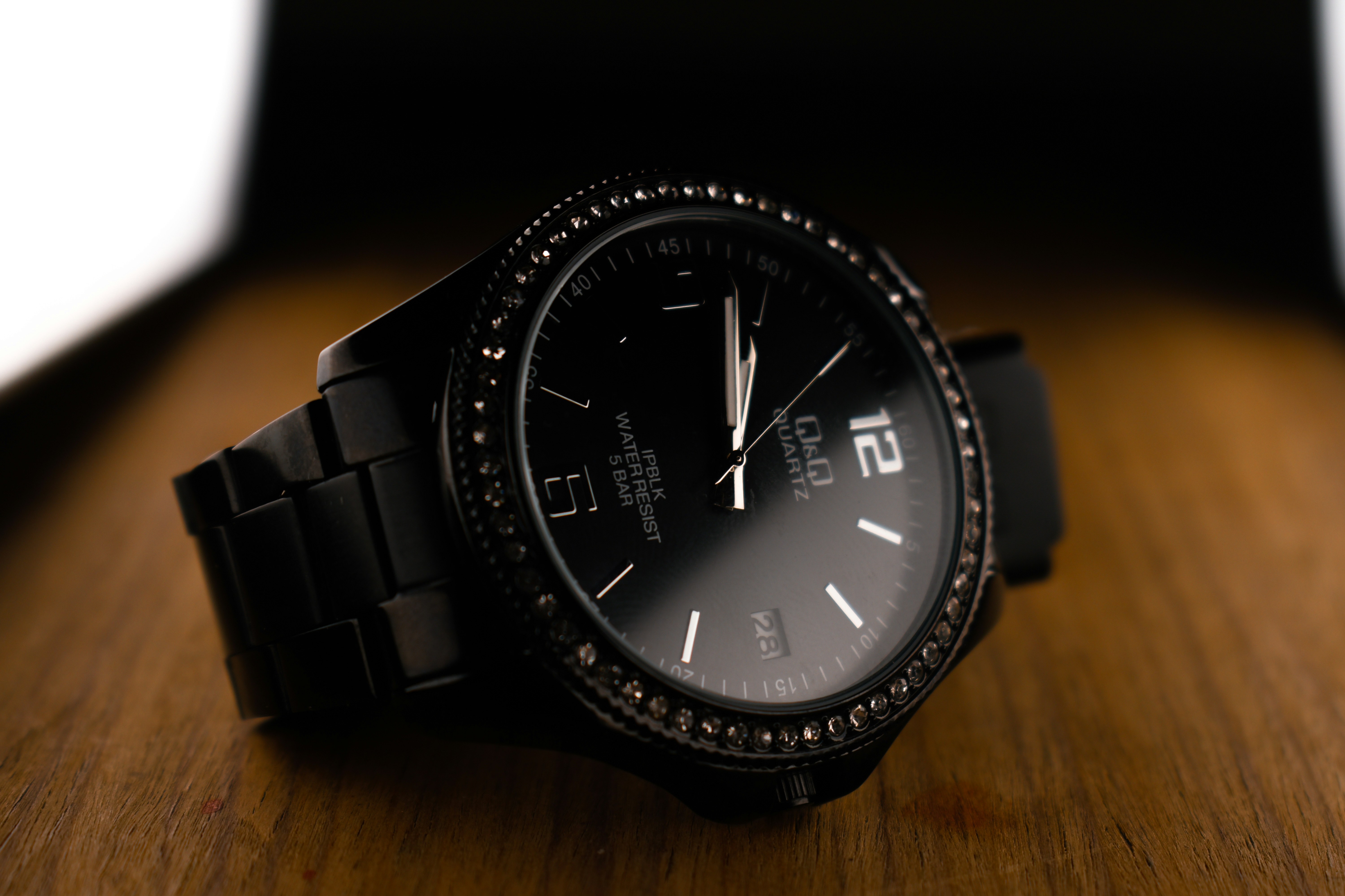 a black watch on a wooden surface
