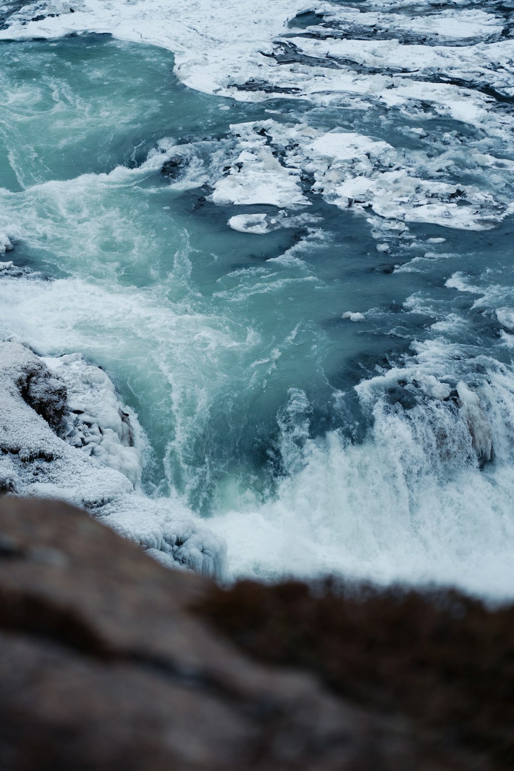 a body of water with ice and snow on it