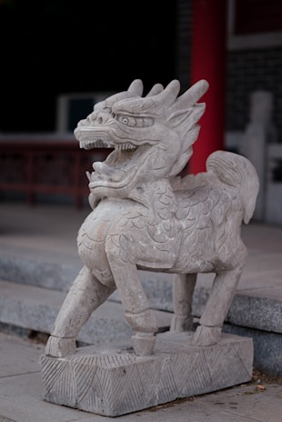 A detailed 3D sculpture of a fierce mythical creature in a dynamic pose.