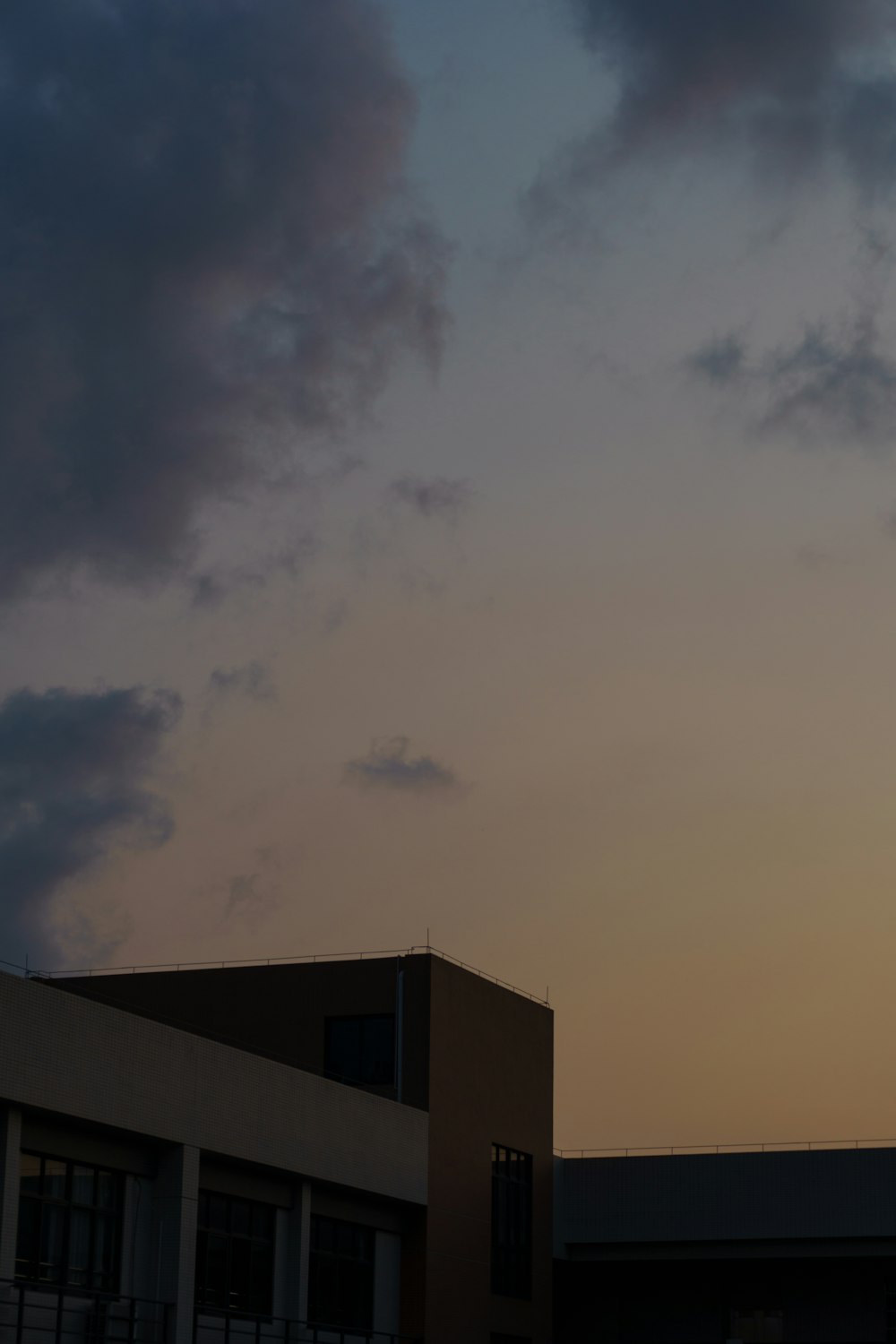 a building with a cloudy sky above