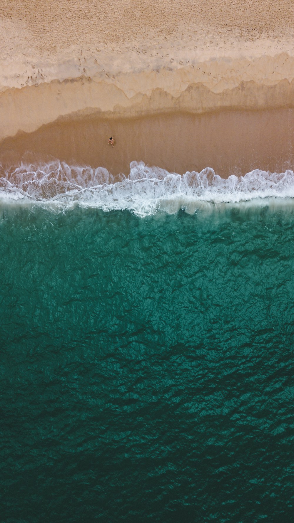 a person riding a wave on a surfboard in the water