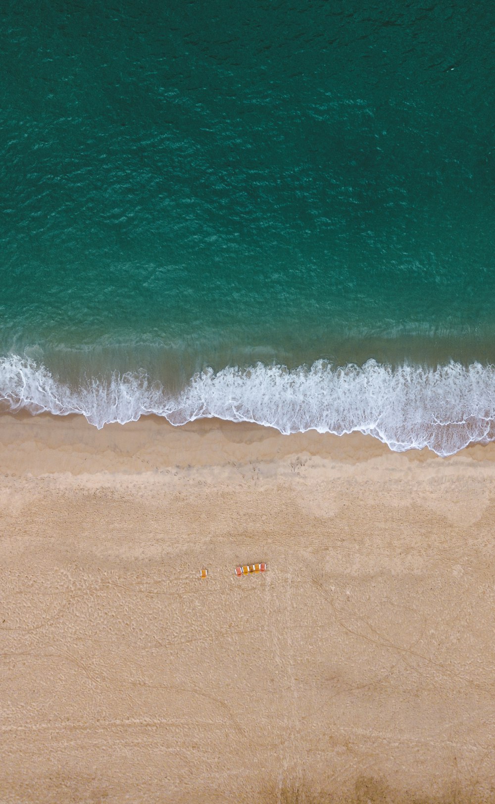 a person riding a wave on top of a beach