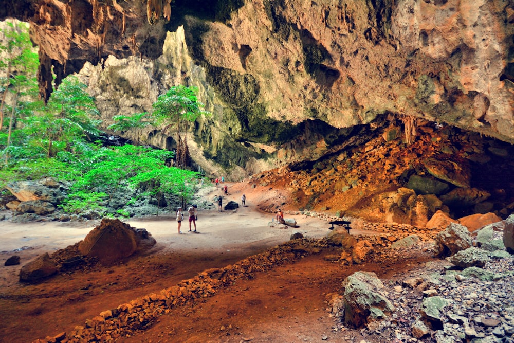 people walking in a cave