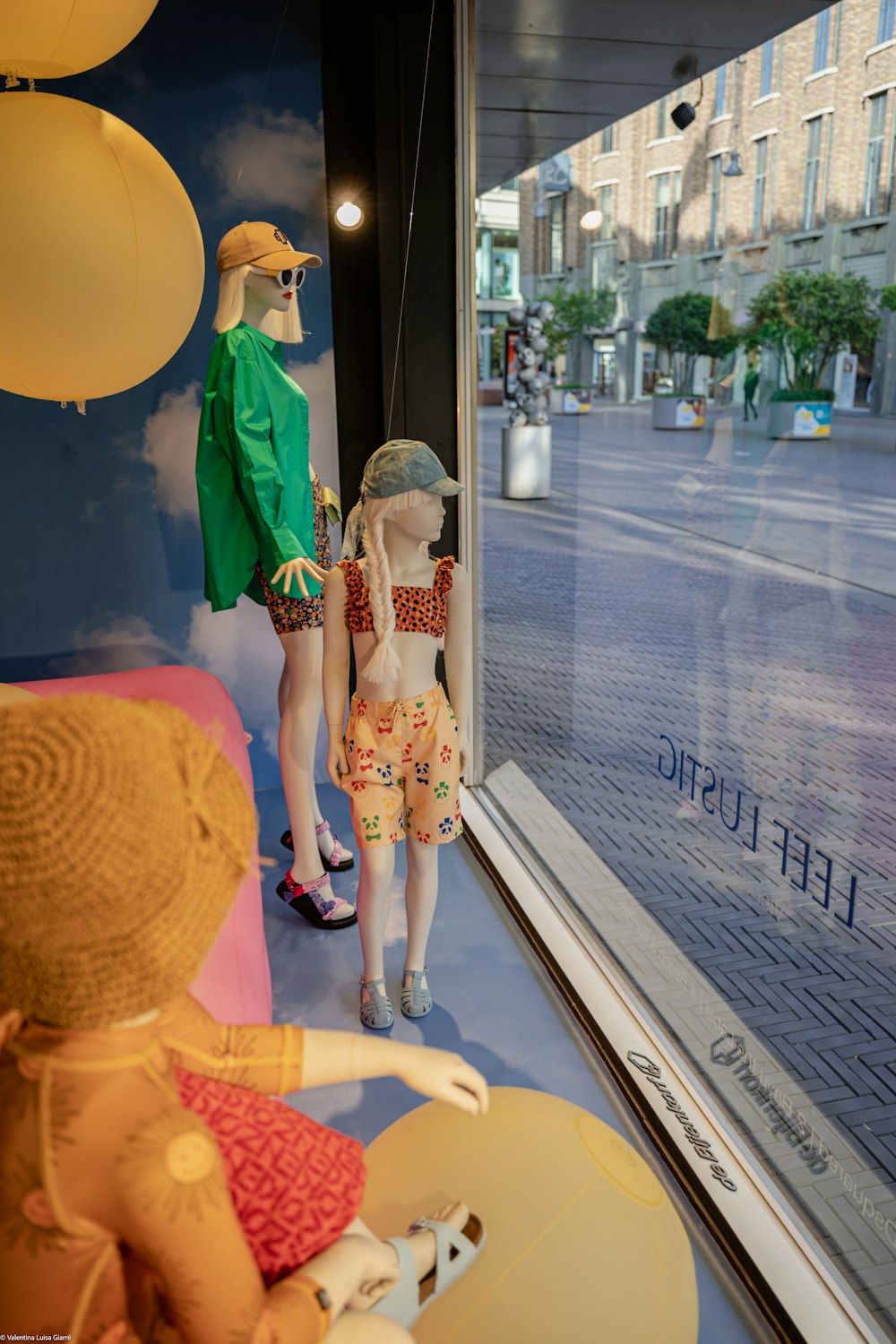 a couple of mannequins in a window display