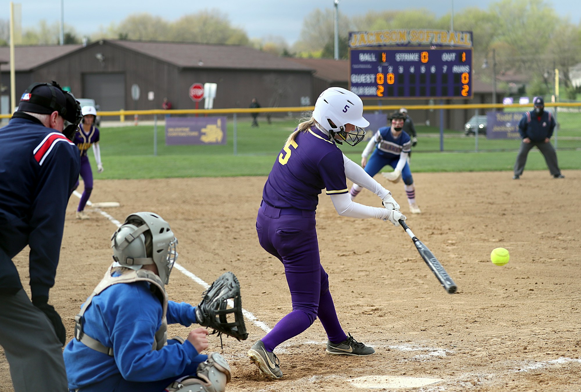 a person hitting a ball with a baseball bat