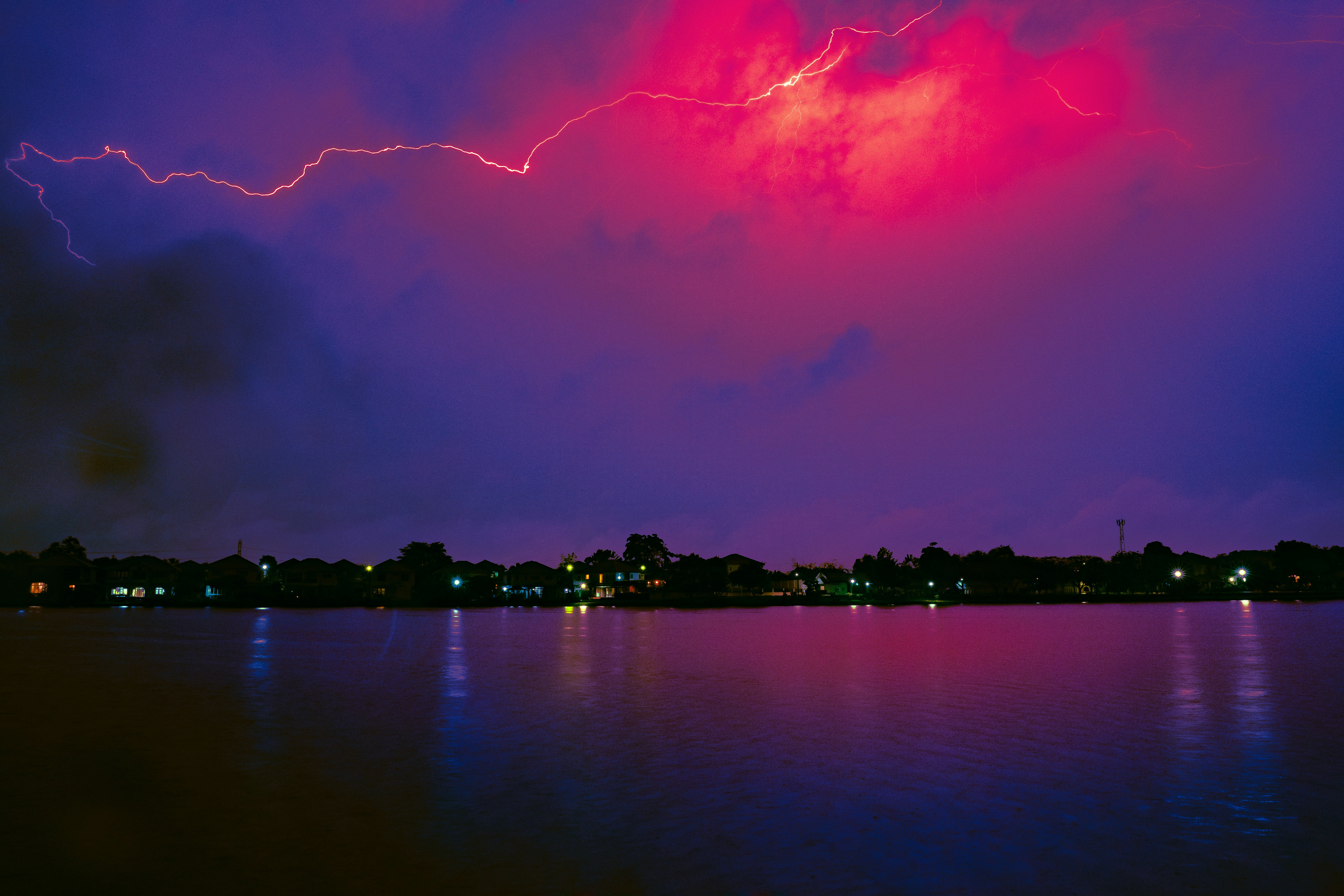 a body of water with a city in the background