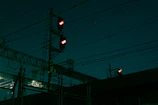 Nighttime shot of illuminated transmission lines connecting powered land platforms.