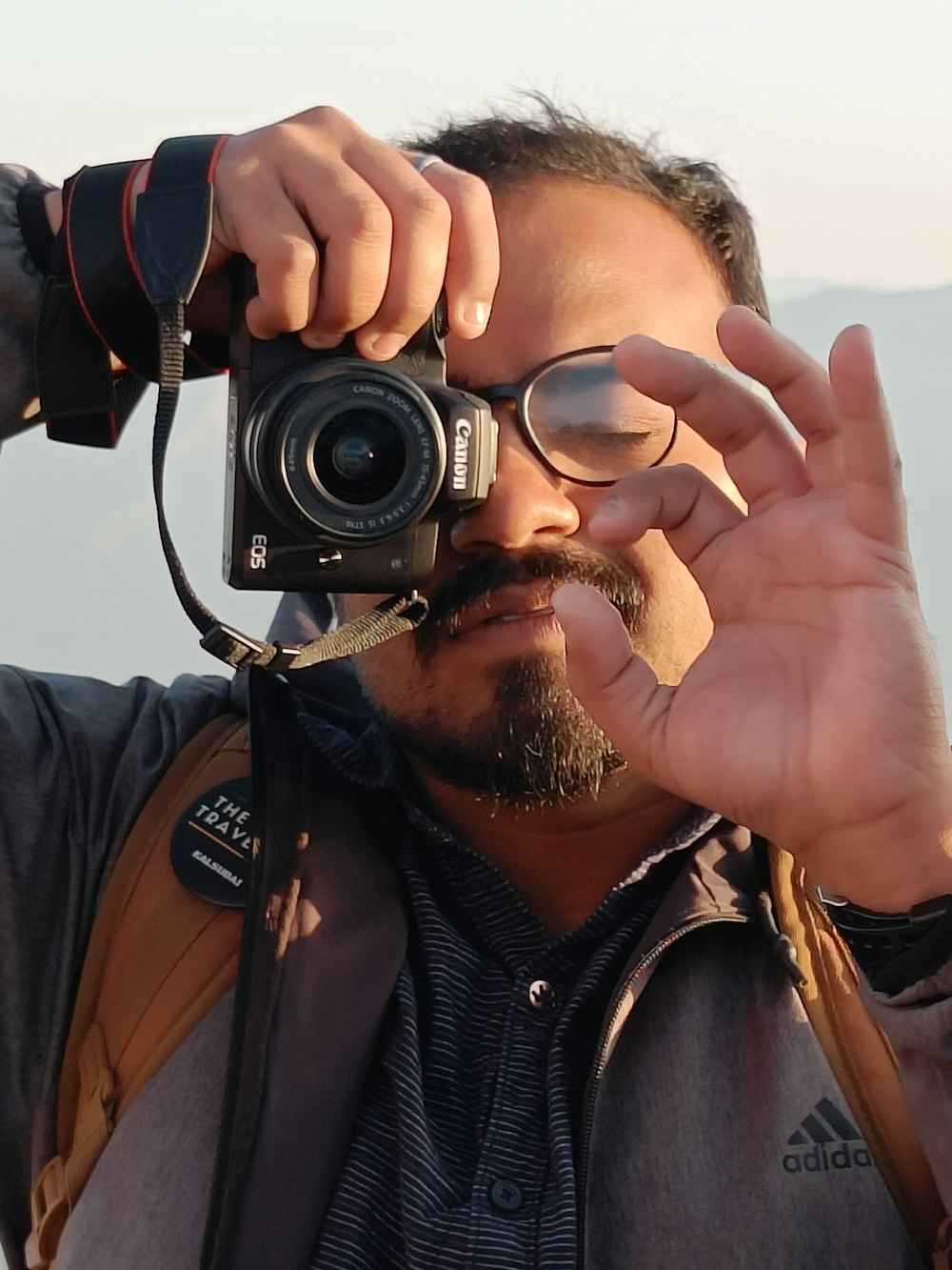 a man holding a camera to his face