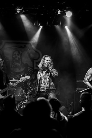 A choir performing passionately on stage with a grand piano in the background.
