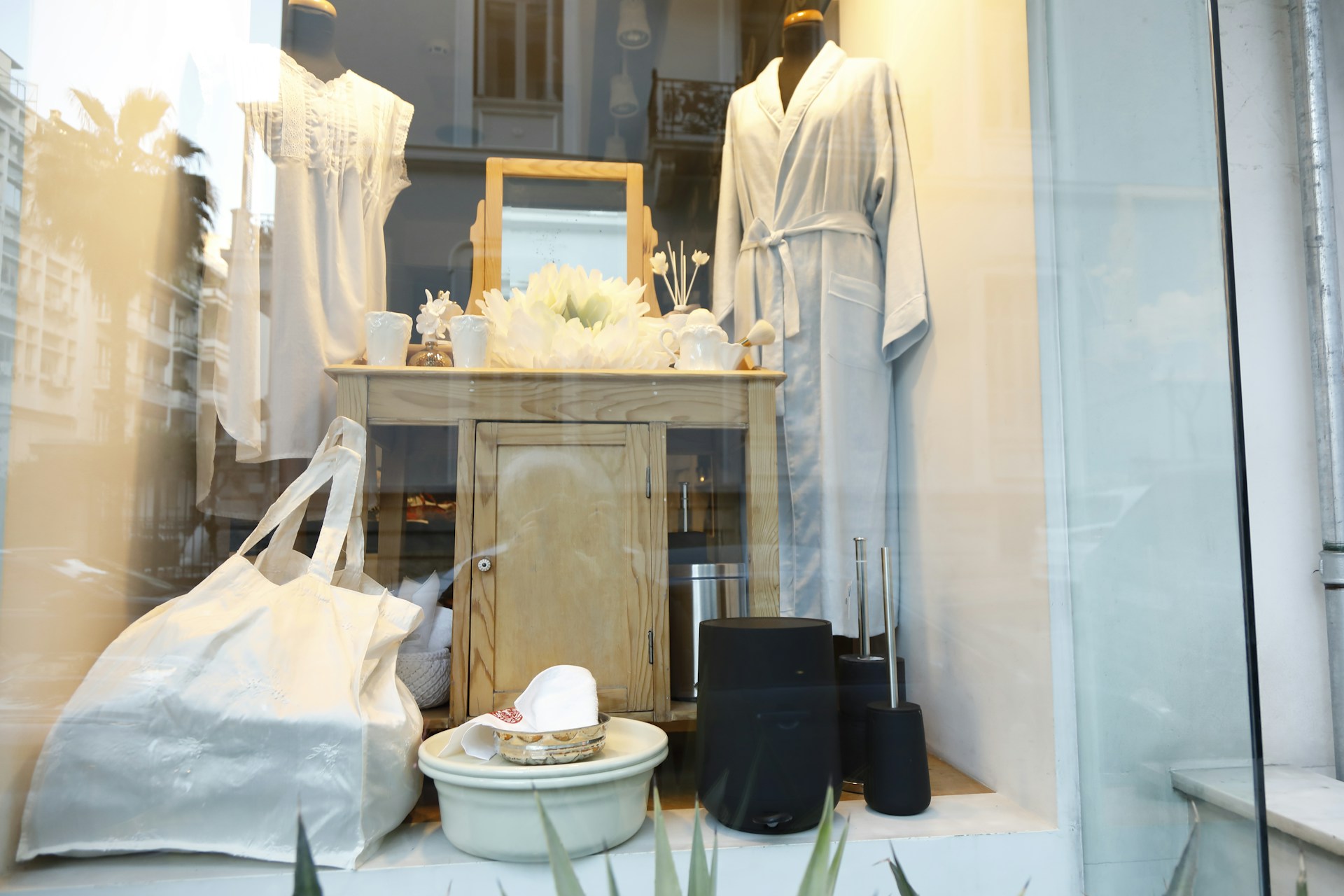 a mannequin in a white dress in a room with a mirror