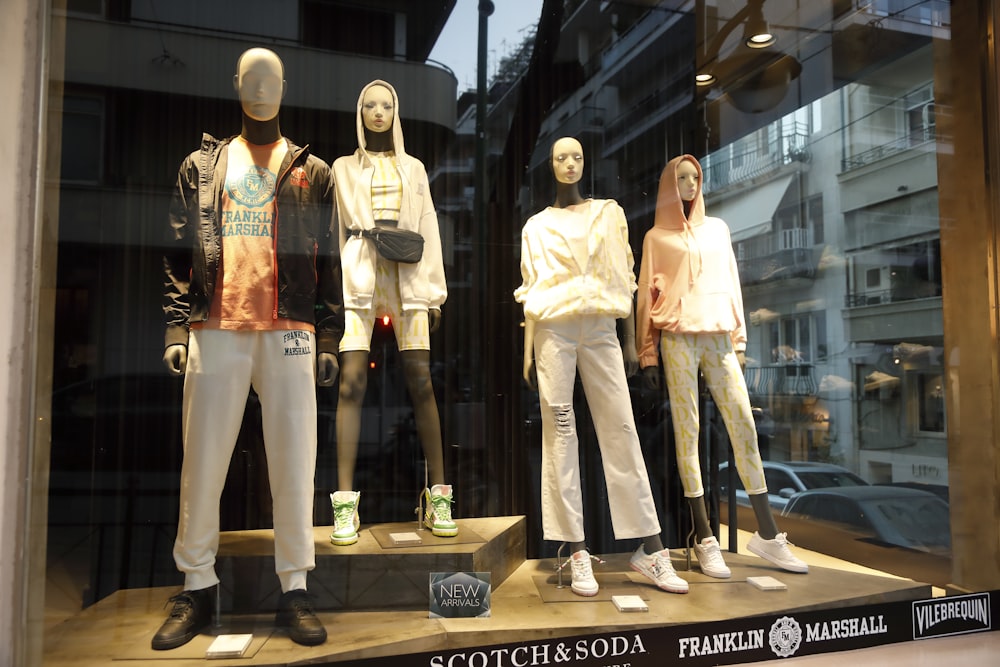 a group of mannequins in a window