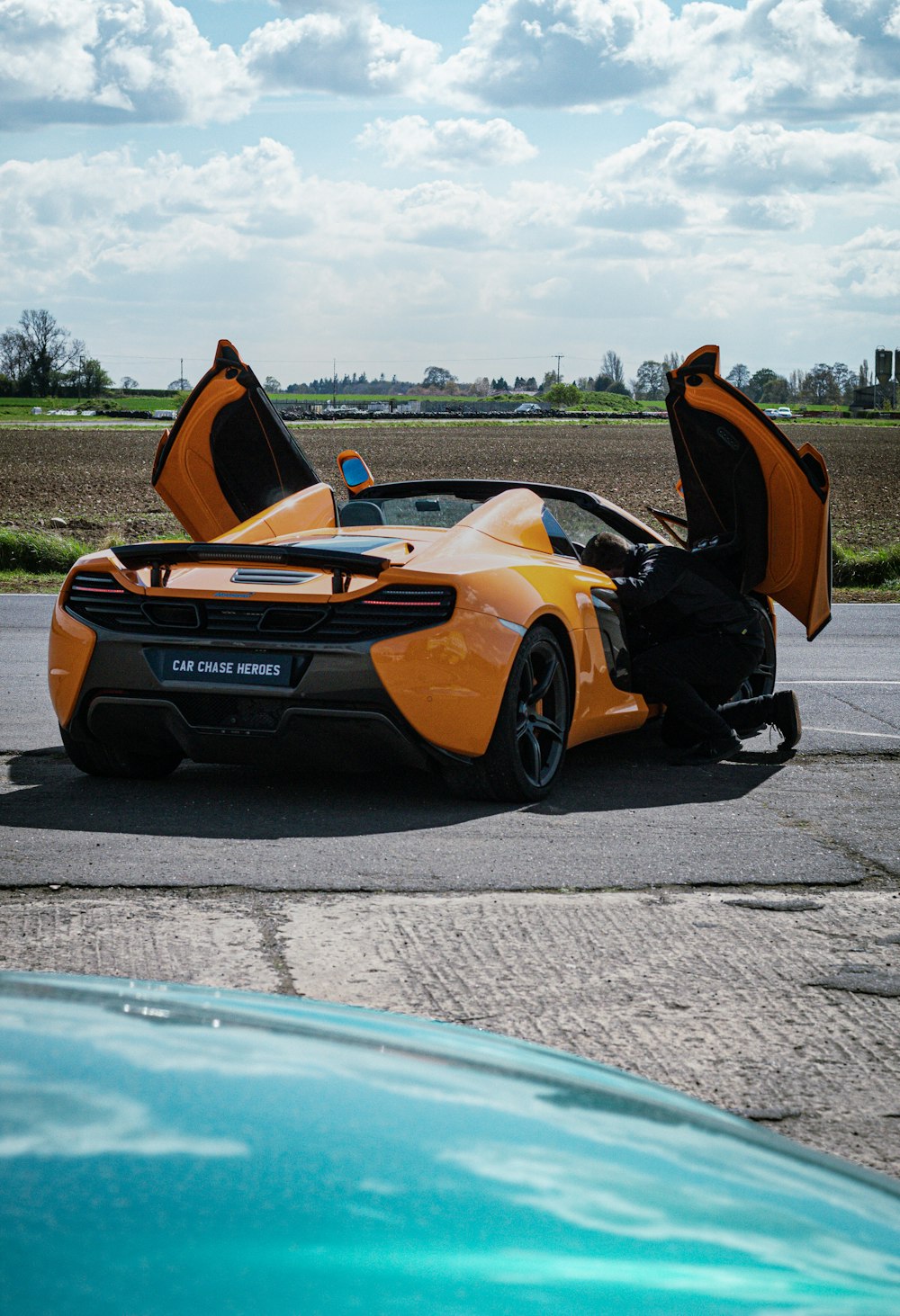 a yellow sports car with the doors open