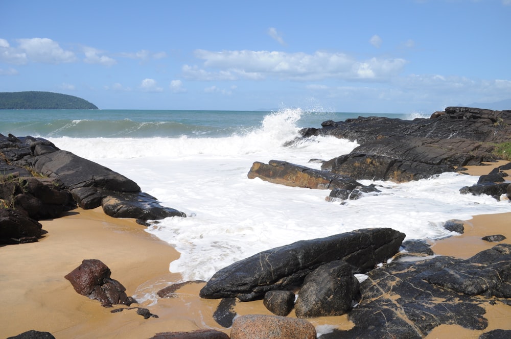 a rocky beach with waves crashing