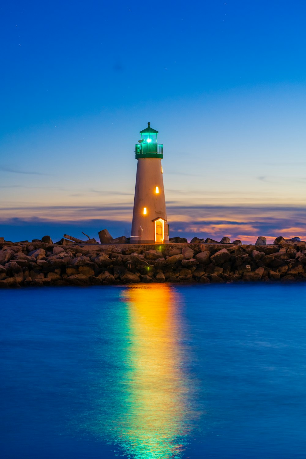 a lighthouse on a rocky island